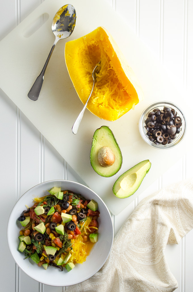 Easy Spaghetti Squash with Pinto Beans and Arugula - this simple recipe offers a lovely blend of Mexican cuisine inspired flavors - squash is cooked in a slow cooker for added convenience | VeggiePrimer.com