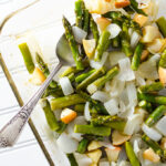 Simple Roasted Asparagus with Apple & Onion - this simple vegan and gluten-free recipe mixes the earthy taste of asparagus with the sweet flavors of apple and onion. It makes a great side dish or serve it on a bed of brown rice for a complete meal! | VeggiePrimer.com
