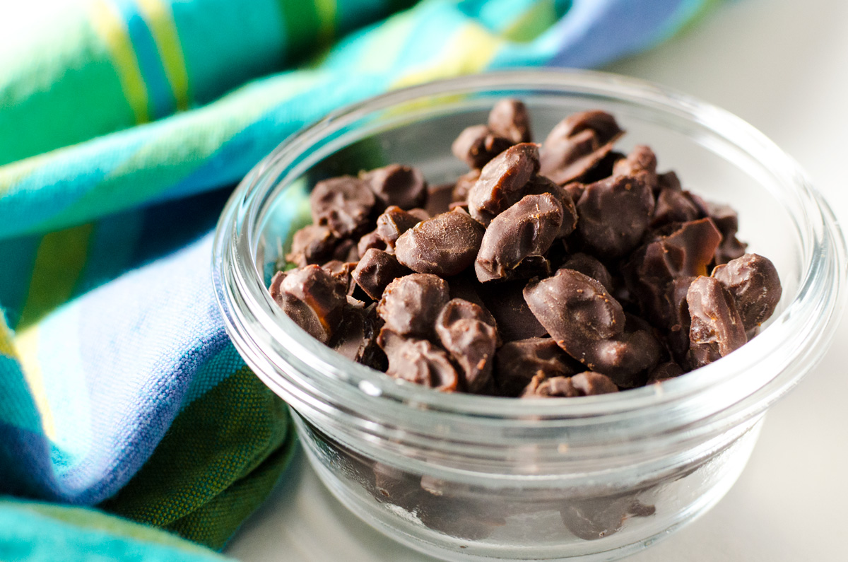 homemade chocolate covered raisins in a glass bowl