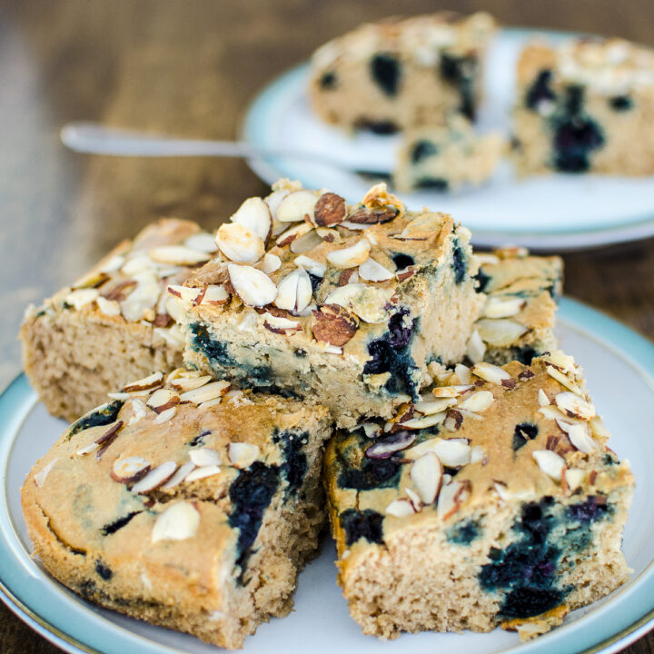 slices of vegan gluten-free blueberry snack cake piled on a plate