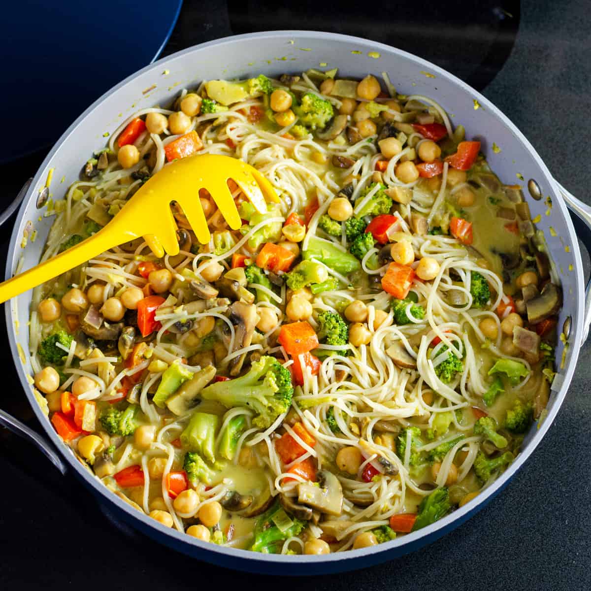 vermicelli noodles added to simple coconut curry recipe in a sauté pan